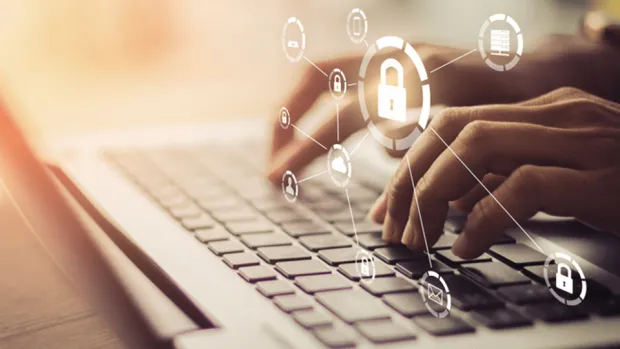 Hands on laptop with a data security icon